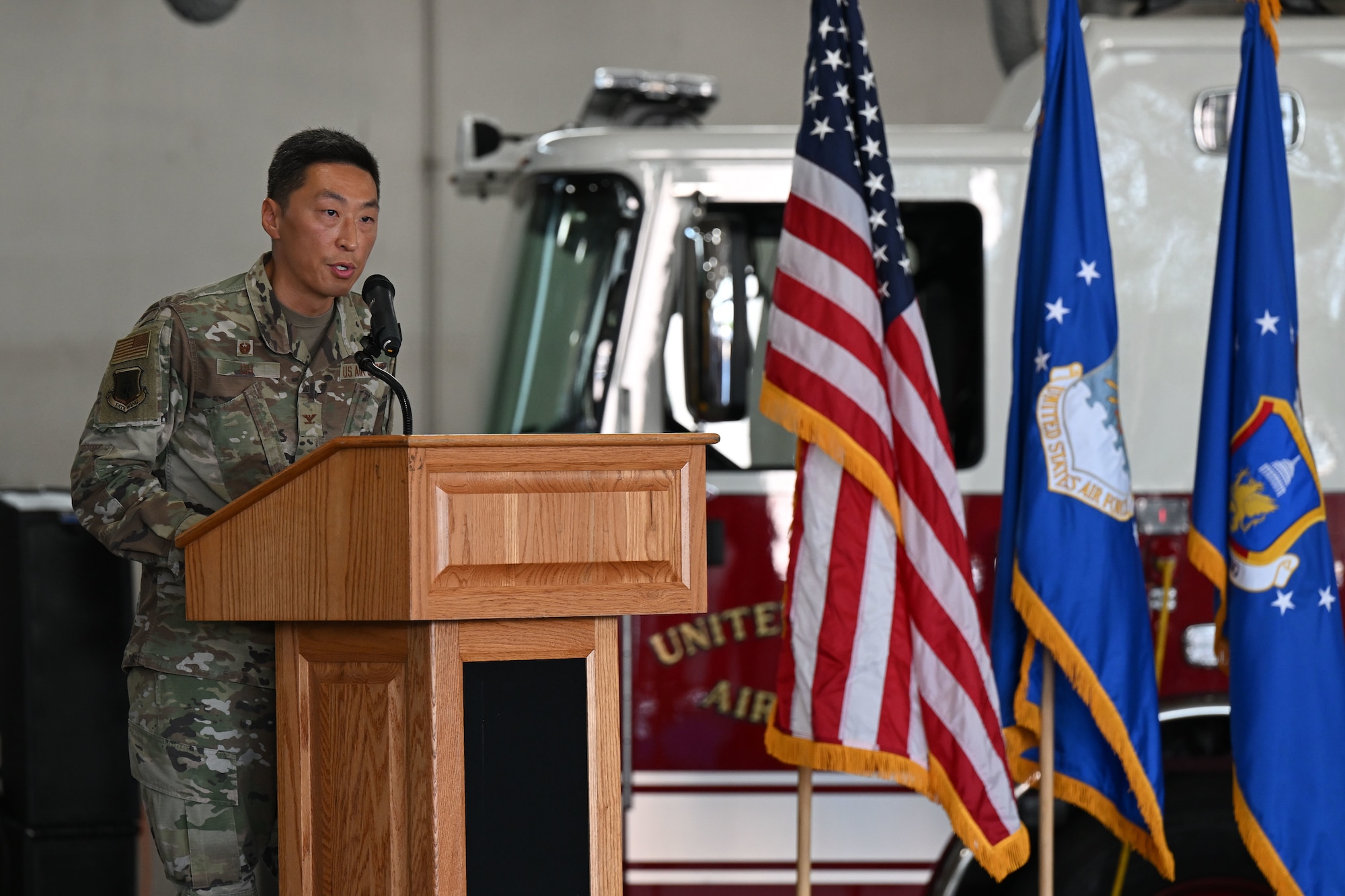 Man in uniform speaks from a podium.
