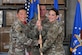 Military members holding a blue flag.