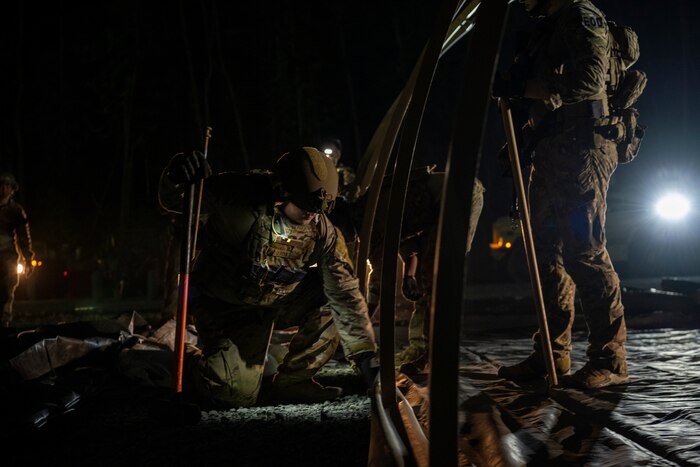 A U.S. Air Force Airman sets up a tent during Exercise Tanuki Bandit 24 at Draughn Range near Misawa Air Base, Japan, June 23, 2024.