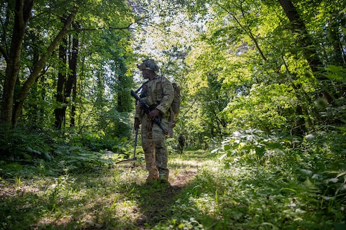 A U.S. Air Force explosive ordnance disposal technician participating in Exercise Tanuki Bandit 24 scans terrain during a patrol at Draughn Range near Misawa Air Base, Japan, June 27, 2024.