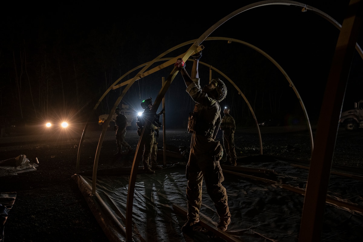 A U.S. Air Force Airman sets up a tent during Exercise Tanuki Bandit 24 at Draughn Range near Misawa Air Base, Japan, June 23, 2024.