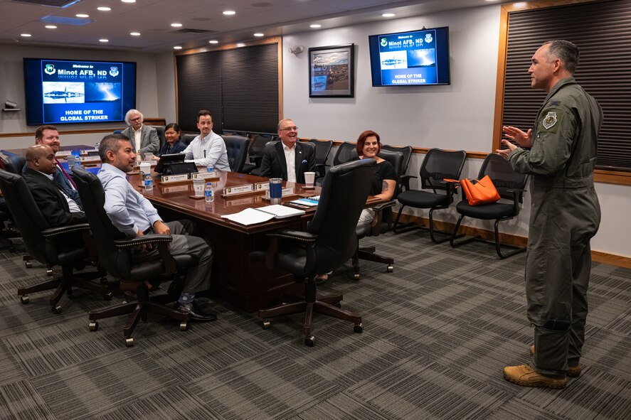 U.S. Air Force Col. Jesse Lamarand, 5th Bomb Wing commander, provides a welcome briefing to members of the Defense Nuclear Facilities Safety Board (DNFSB) during a base visit at Minot Air Force Base, North Dakota, June 10, 2024. The mission of the DNFSB is to provide independent analysis, advice, and recommendations to the President and Secretary of Energy regarding defense nuclear facilities. (U.S. Air Force photo by Senior Airman Kyle Wilson)