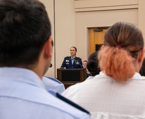 Col. Carolyn Ammons stands at podium and addresses audience