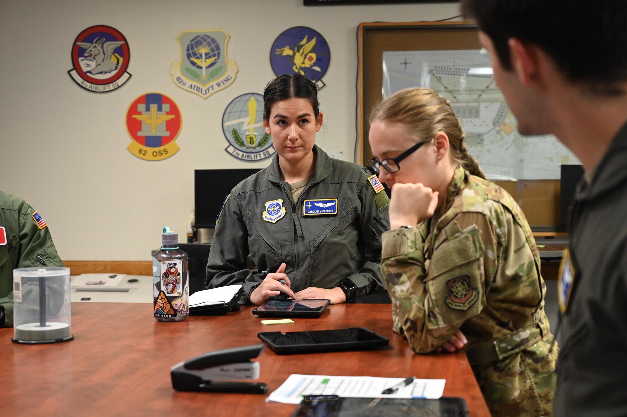 U.S. Air Force 1st Lt. Carolyn Mickelson, an aircrew development flight officer with the 7th Airlift Squadron, receives a brief before a local flight with cadets from the United States Air Force Academy at Joint Base Lewis-McChord, Washington, July 2, 2024.