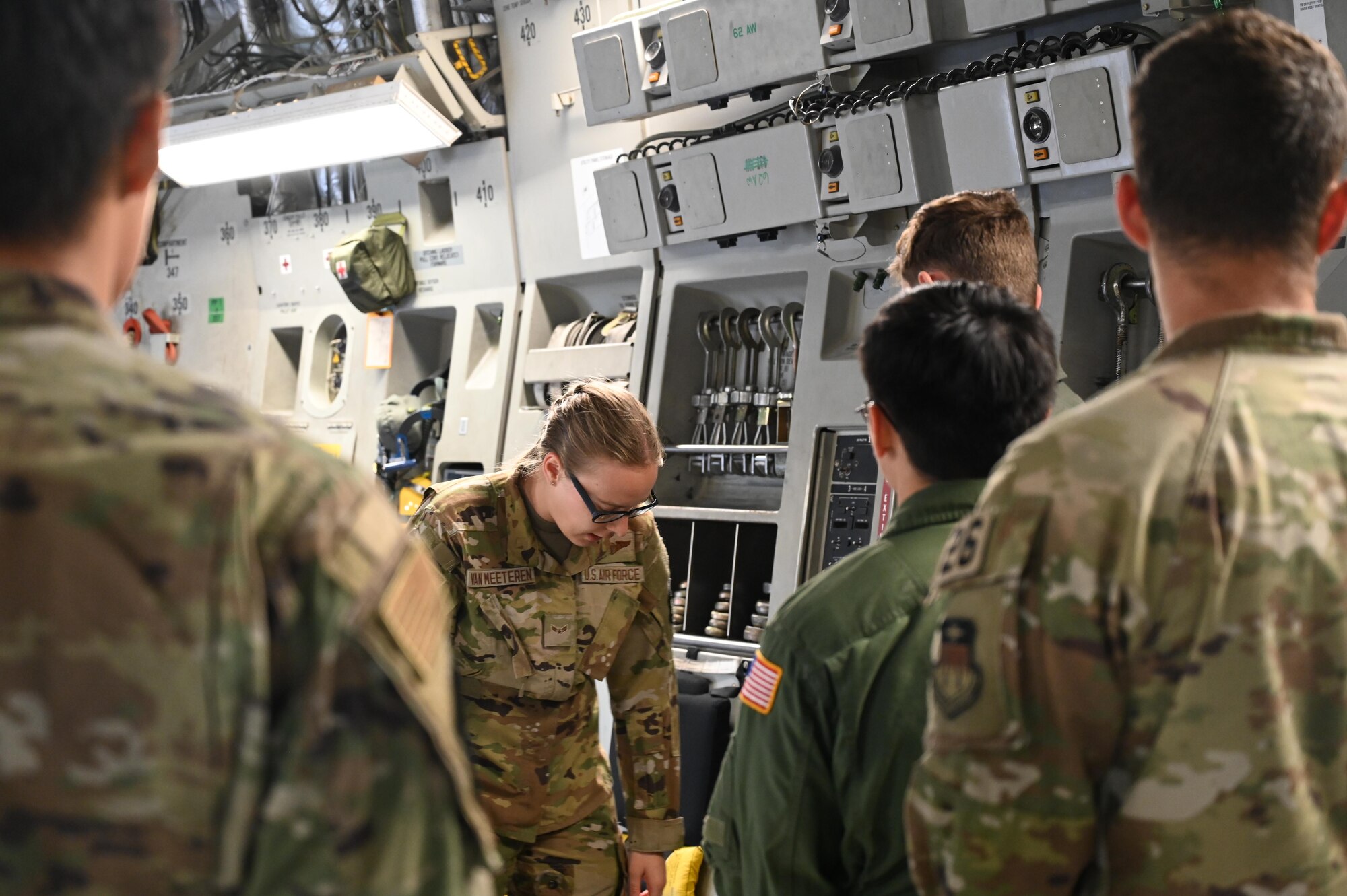 U.S. Air Force Airman 1st Class Helena Van Meeteren, a load master with the 7th Airlift Squadron, gives a safety briefing to cadets visiting from the United States Air Force Academy during a local flight at Joint Base Lewis-McChord, Washington, July 2, 2024.