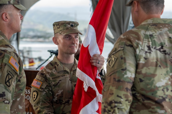 Lt. Col. Adrian Biggerstaff, incoming District Commander for the U.S. Army Corps of Engineers Honolulu District, symbolically assumes command after receiving the unit colors from Brig. Gen. Joseph C. “Clete” Goetz II, Commanding General for the U.S. Army Corps of Engineers Pacific Ocean Division in a July 10 ceremony aboard the Battleship Missouri Memorial.