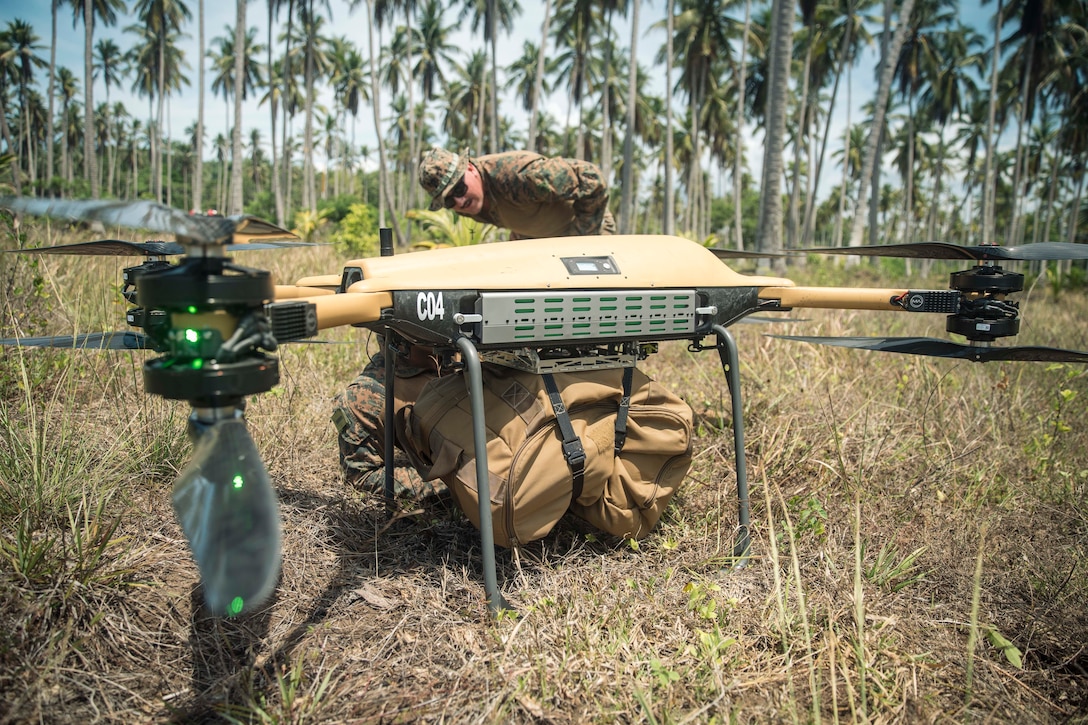 U.S. Marines inspect a load of cargo secured to a Tactical Resupply Unmanned Aircraft System before flight at a coastal defense site during Archipelagic Coastal Defense Continuum on Kamuning Beach, Palawan, Philippines, May 15, 2024. The TRUAS is a Class 3 unmanned aerial vehicle that can deliver supplies to remote and inaccessible areas. CLB-15 is employing the TRUAS as part of experimentation for expeditionary resupply concepts. (U.S. Marine Corps photo by Cpl. Joseph Helms)
