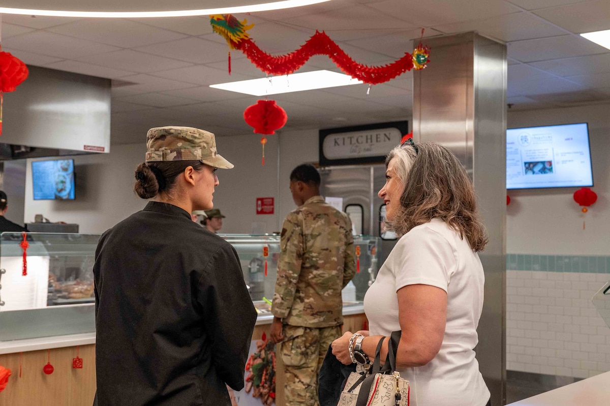 Gina Allvin, the spouse of the United States Air Force Chief of Staff Gen. David Allvin, engages with an Airman in the Desert-Inn dining facility at Davis-Monthan Air Force Base, Ariz., July 9, 2024. Allvin was escorted by other key spouses to various locations on base including the wing headquarters, the Military and Family Readiness Center, the Desert-Inn dining facility and the community center. (U.S. Air Force photo by Airman 1st Class Jhade Herrera)