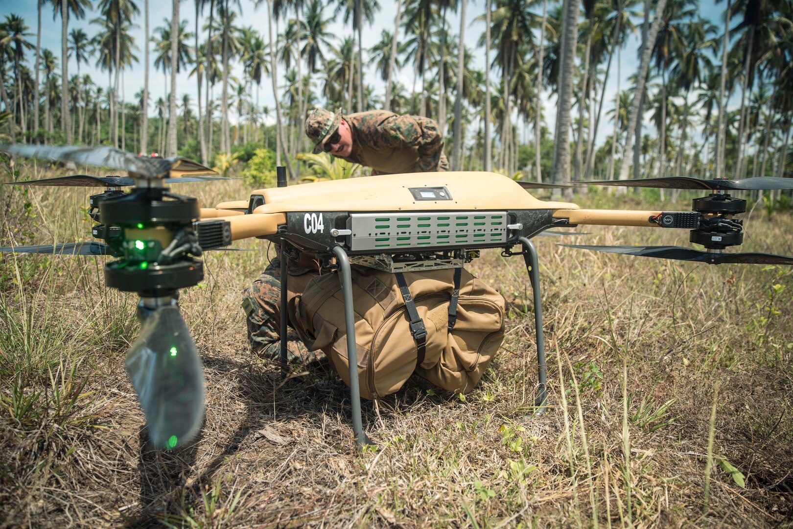 U.S. Marines inspect a load of cargo secured to a Tactical Resupply Unmanned Aircraft System before flight at a coastal defense site during Archipelagic Coastal Defense Continuum on Kamuning Beach, Palawan, Philippines, May 15, 2024. The TRUAS is a Class 3 unmanned aerial vehicle that can deliver supplies to remote and inaccessible areas. CLB-15 is employing the TRUAS as part of experimentation for expeditionary resupply concepts. (U.S. Marine Corps photo by Cpl. Joseph Helms)