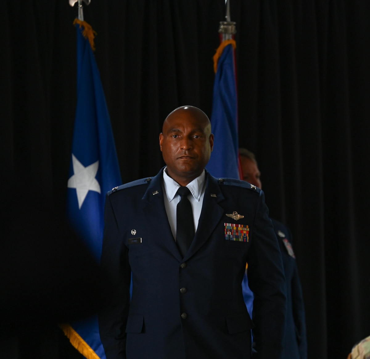 U.S. Air Force Col. Larry Fenner Jr., 350th Spectrum Warfare Wing commander, stands at attention after rendering his first salute to the wing after taking command at Eglin Air Force Base, Florida, July 9, 2024. Fenner is the wing’s third commander and previously served as the deputy wing commander for the 36th Wing at Anderson AFB, Guam. (U.S. Air Force photo by Capt. Benjamin Aronson)