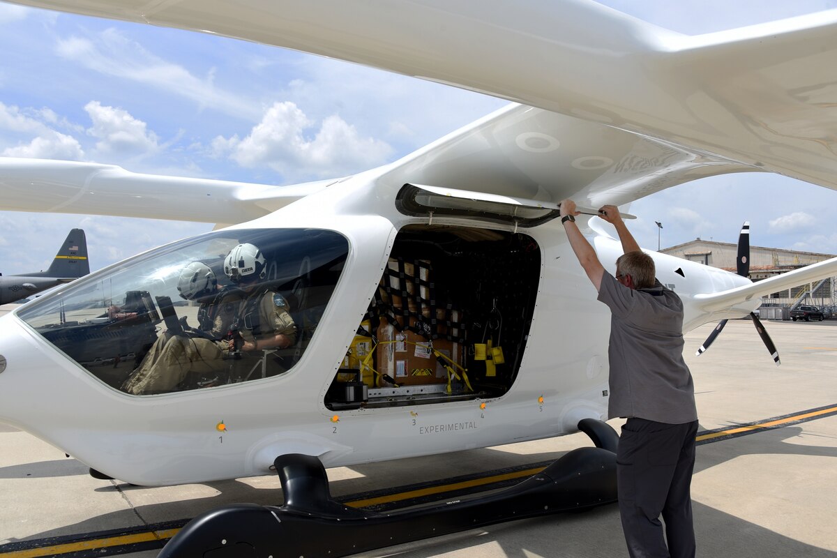 Posit Moyer, test pilot, and Ross Elkort, test engineer, prepare BETA Technologies’ prototype, ALIA CTOL, a battery-powered fixed-wing aircraft, for takeoff at Joint Base McGuire-Dix-Lakehurst, N.J., July 9, 2024. A team from the 305th Maintenance Squadron’s Precision Measurement Equipment Laboratory loaded the aircraft with 222 pounds of cargo for delivery to Dover Air Force Base, Del. BETA partnered with AFWERX Agility Prime to test the capabilities of moving cargo between bases in a safer, cleaner and more cost-effective way. (U.S. Air Force photo by Master Sgt. Joseph Vigil)