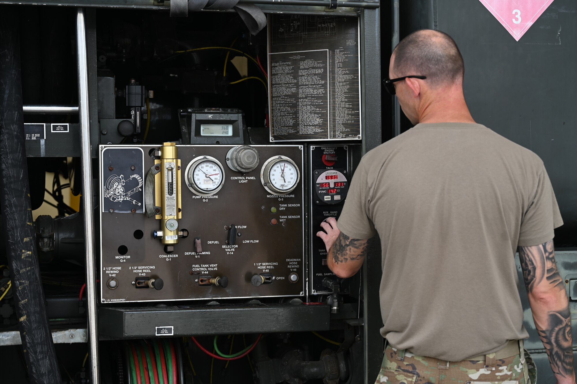 An Airman views and operates a control panel that is attached to the R-11 Refueler truck.