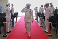 Capt. Kenneth S. Pickard, the commanding officer of Commander, Task Force 63/Military Sealift Command Europe and Africa, salutes as he walks towards his seat during change of command ceremony, July 10, 2024.