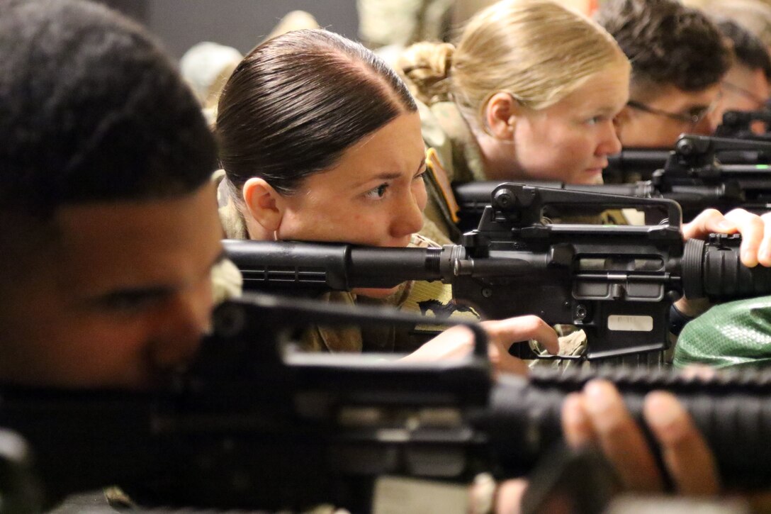 Several soldiers aim their weapons at targets.