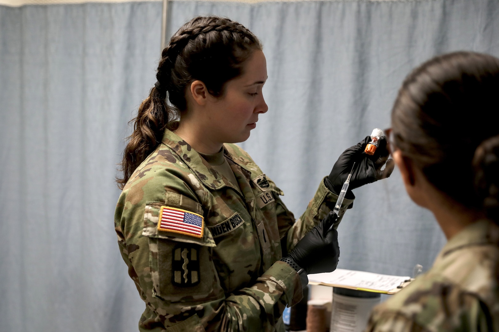 1st Lt. Jennifer Vanden Busch, the Joint Readiness Training Center Aid Station Rear operations officer, prepares a syringe June 13 during the 24-08 training rotation for the Wisconsin Army National Guard’s 32nd “Red Arrow” Infantry Brigade Combat Team. She was among the medics, nurses and physicians from the Wisconsin National Guard and surrounding states who responded to a call for volunteers to staff the JRTC clinic. 32nd Infantry Brigade Combat Team photo by Staff Sgt. Kati Volkman