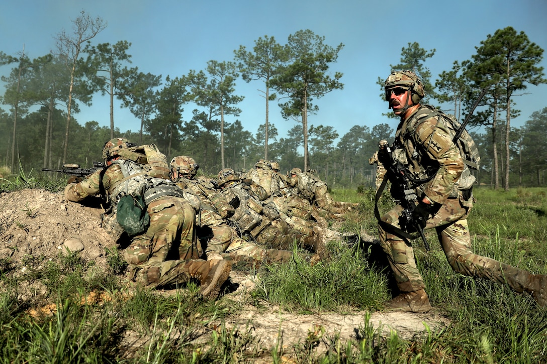 Soldiers from the Wisconsin Army National Guard’s 32nd “Red Arrow” Infantry Brigade Combat Team take up a hasty fighting position June 8 during a rotation at the Joint Readiness Training Center, Fort Johnson, La. The Red Arrow led more than 5,000 Soldiers from across the United States and Canada in simulated large-scale combat operations. This realistic training builds readiness for overseas deployments and prepares Soldiers to survive the rigors of war. 32nd IBCT photo by Staff Sgt. Kati Volkman