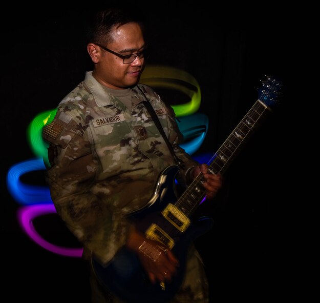 U.S. Air Force Master Sgt. Jonathan Salvador, 705 Munitions Squadron non-commissioned officer in charge, plays guitar in a studio on Minot Air Force Base, North Dakota, July 9, 2024. Salvador was previously named best in the show after performing a rendition of the song "Smooth" by musician Carlos Santana at the 2011 Air Force Worldwide Talent Search competition. (U.S. Air Force photo by Senior Airman Alexander Nottingham)