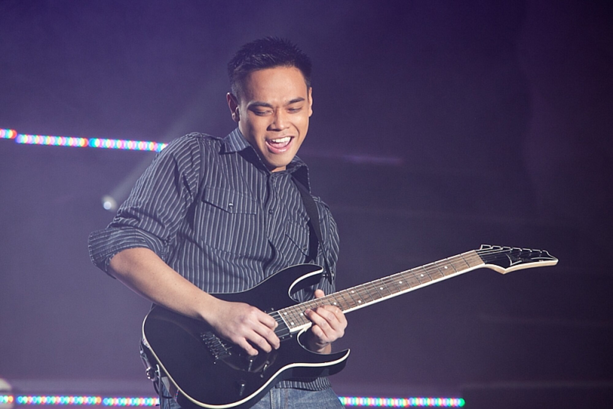 Airman 1st Class Jonathan Salvador, 17th Munitions Squadron air-launched cruise missile maintenance team member performs an electric guitar solo at the Bob Hope Performing Arts Center, during the Air Force Worldwide Talent Search on Dec. 10, 2010. Airman Salvador was named best in show and top musician for the competition. (Courtesy photo)
