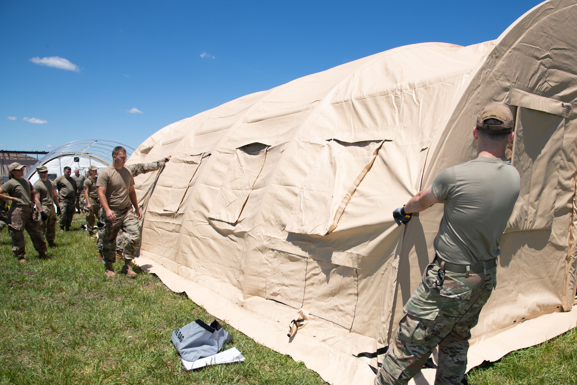 Airmen assigned to the 171st Civil Engineer Squadron in Pittsburgh, Pennsylvania, and the 177th Civil Engineer Squadron erect Disaster Relief Beddown System tents as part of the Piney Devil training exercise, June 8, 2024, on Atlantic City Air National Guard Base, Egg Harbor Township.