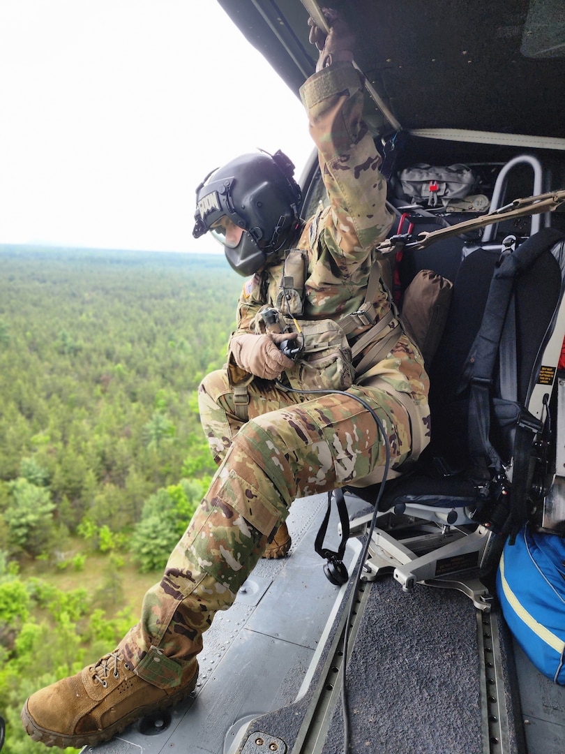 Sgt. Zachary Hintze, a crew chief assigned to a Wisconsin Army National Guard UH-60 Black Hawk crew from West Bend, Wis., looks for a scenario-based missing person during a search and rescue training exercise June 1 in Jackson County, Wis. The Black Hawk crew collaborated with Trail Ambassadors and the emergency management offices of Jackson County and the Ho-Chunk Nation. Wisconsin National Guard photo by 1st Lt. Charnelle Pinson