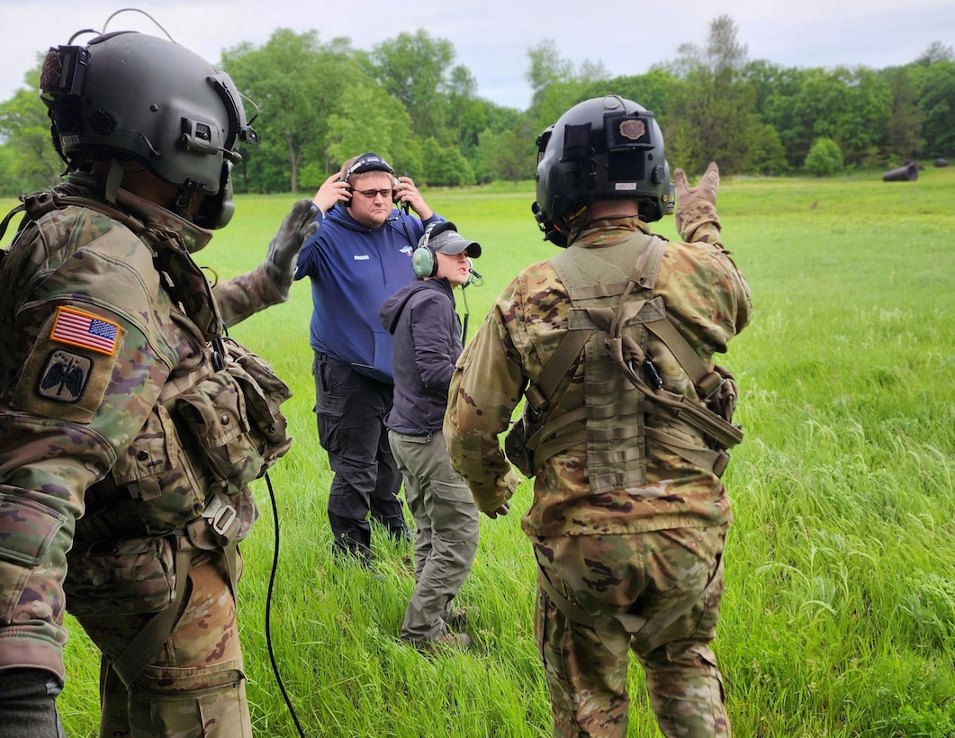 Sgt. 1st Class Eric Furbee and Sgt. Zachary Hintze, assigned to a Wisconsin Army National Guard UH-60 Black Hawk crew from West Bend, Wis., escort Adam Harden and Katie Sowinski off the helicopter to a safe distance after completing a search and rescue training scenario June 1 in Jackson County, Wis. The Black Hawk crew collaborated with Trail Ambassadors and the emergency management offices of Jackson County and the Ho-Chunk Nation. Wisconsin National Guard photo by 1st Lt. Charnelle Pinson