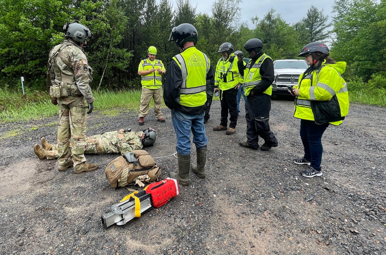 Sgt. 1st Class Eric Furbee, a critical care flight paramedic assigned to a Wisconsin Army National Guard UH-60 Black Hawk crew from West Bend, Wis., explains how a patient is hoisted into a Black Hawk to Trail Ambassador members during a search and rescue training exercise June 1 in Jackson County, Wis. The Black Hawk crew collaborated with Trail Ambassadors and the emergency management offices of Jackson County and the Ho-Chunk Nation. Photo courtesy Wisconsin Trail Ambassadors Program