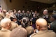 group of men and women wearing U.S. Army uniforms standing in a group talking.