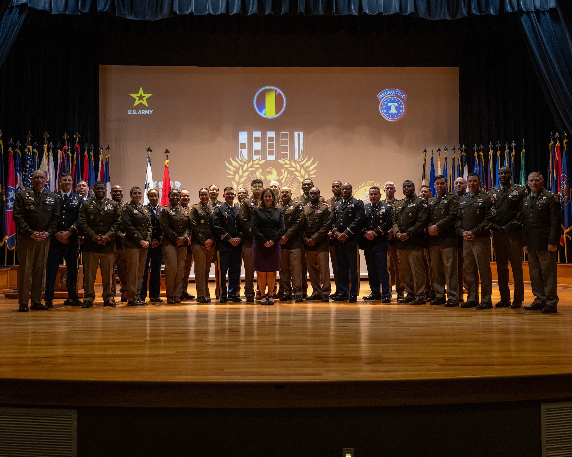 group of men and women pose for a photo in U.S. Army uniforms.