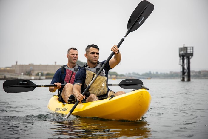 ​U.S. Marine Corps Capt. Charles Palmer, a series commander with Lima Company, left, and Capt. Aaron Zendejas, a series commander with India Company, right, both with 3rd Recruit Training Battalion, participate in a kayak team-building event at the Marina on Marine Corps Recruit Depot San Diego, July 1, 2024. The staff of 3rd Recruit Training Battalion conducted a kayak team-building event as part of sergeant major's battalion physical training to foster unit cohesion between the officers and enlisted Marines. (U.S. Marine Corps photo by Lance Cpl. Eric Valerio)