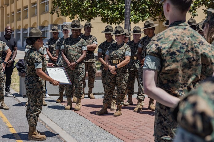 U.S. Marine Corps Gunnery Sgt. Brenda Delosreyes, a drill instructor with Fox Company, 2nd Recruit Training Battalion, speaks to U.S. Marines with Recruit Training Regiment, Marine Corps Recruit Depot San Diego after being meritoriously promoted to the rank of gunnery sergeant at MCRD San Diego, California, July 2, 2024. Delosreyes was meritoriously promoted to the rank of Gunnery Sgt. for her hard work, dedication to duty, and excelling beyond her peers.  Meritorious promotions are based on outstanding performance and the Marine's ability to take on more responsibility and authority. Nominees must also demonstrate leadership skills and be able to fulfill the duties of the next higher grade. (U.S. Marine Corps photo by Sgt. Jesse K. Carter-Powell)