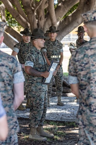 U.S. Marine Corps Staff Sgt. Jose Salcedo, a chief drill instructor with Kilo Company, 3rd Recruit Training Battalion, speaks to U.S. Marines with Recruit Training Regiment, Marine Corps Recruit Depot San Diego after being meritoriously promoted at Marine Corps Recruit Depot San Diego, California, July 2, 2024. Salcedo was meritoriously promoted to the rank of staff sergeant for his hard work, dedication to duty, and excelling beyond his peers.  Meritorious promotions are based on outstanding performance and the Marine's ability to take on more responsibility and authority. Nominees must also demonstrate leadership skills and be able to fulfill the duties of the next higher grade. (U.S. Marine Corps photo by Sgt. Jesse K. Carter-Powell)