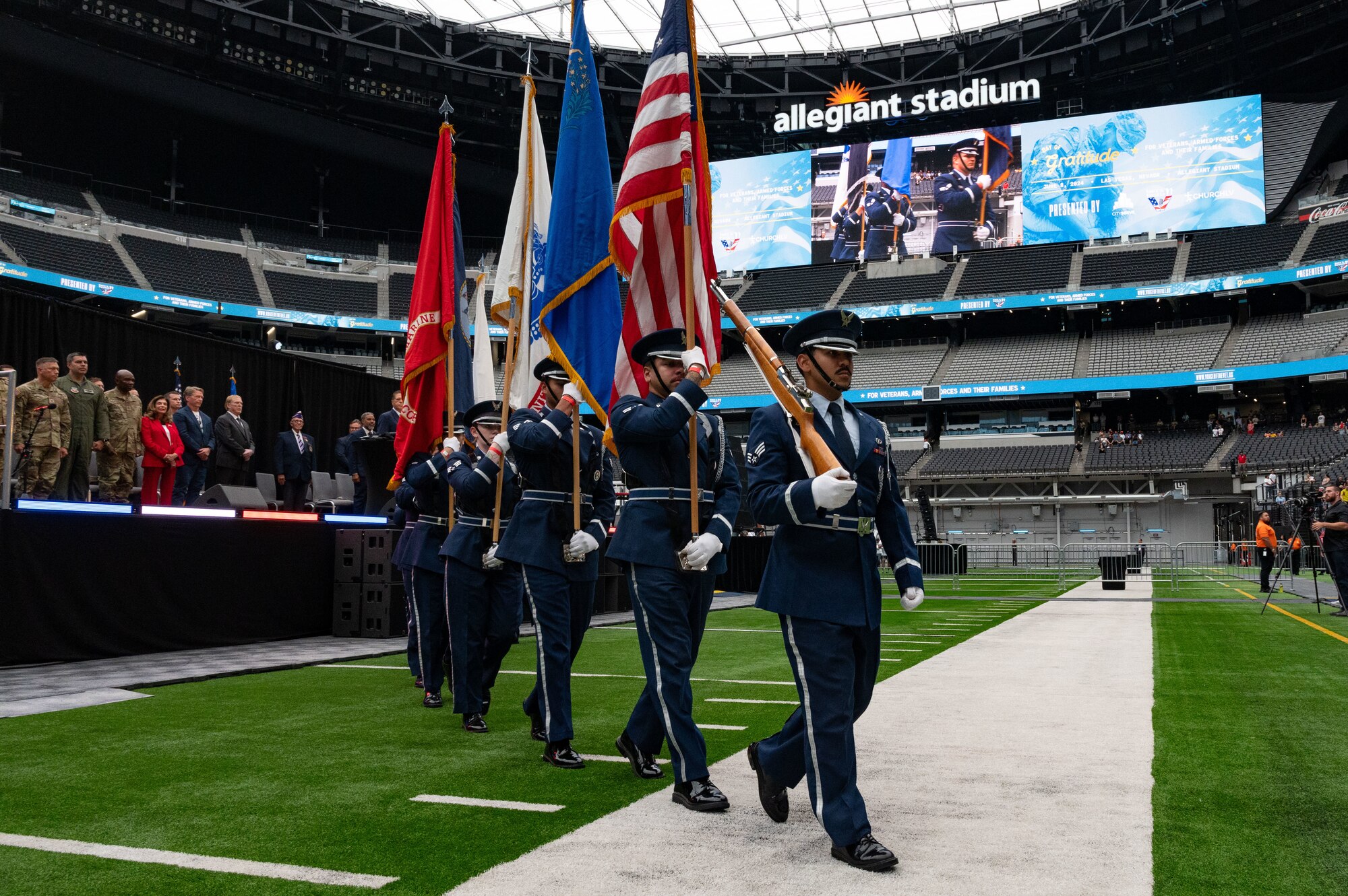 U.S. Air Force honor guard marching in formation while carrying flags of different services