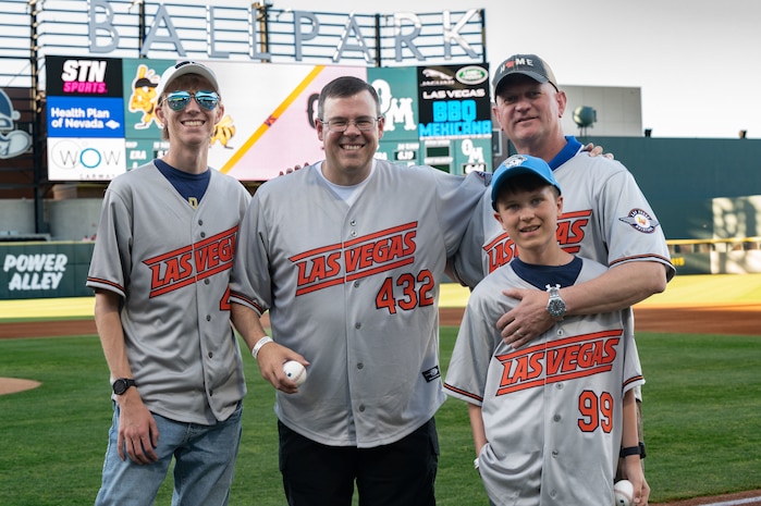 99th Air Base Wing commander, his son, and 432nd Wing commander, his son, pose for a photo