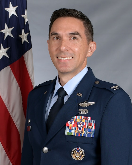 A man in dress uniform smiles at the camera.