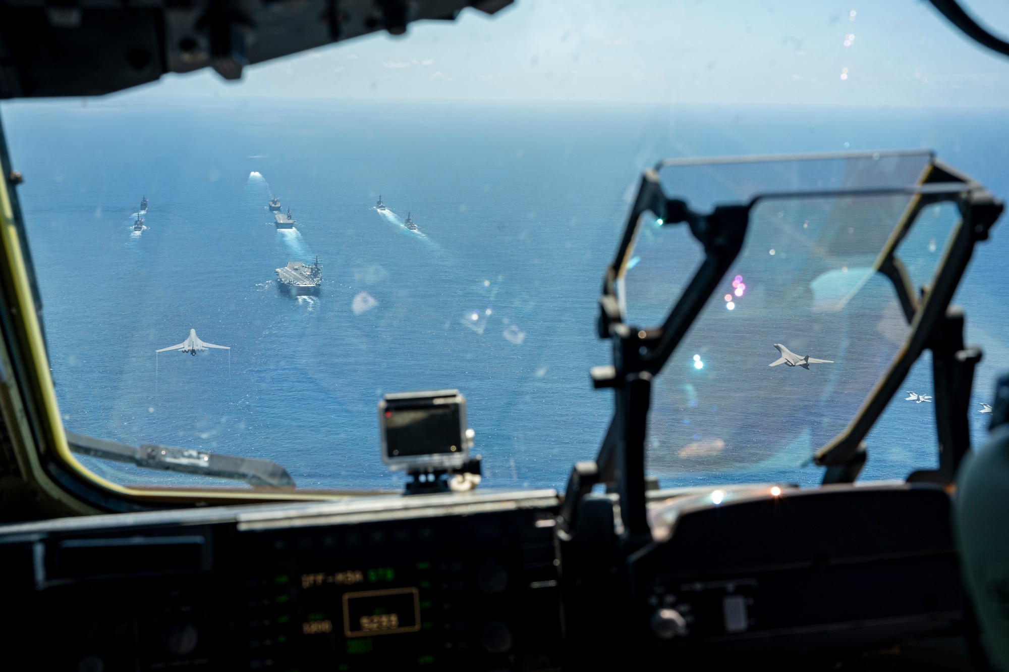 U.S. Air Force B-1B Lancers assigned to the 37th Bomb Squadron and U.S. Navy F/A-18 Hornets assigned to the Carrier Air Wing (CVW) 5 fly in formation above U.S. Navy and Japan Maritime Self-Defense Force ships in the Pacific Ocean in support of Valiant Shield 2024, June 7, 2024. Exercises such as Valiant Shield allow the Indo-Pacific Command Joint Forces the opportunity to integrate forces from all branches of service and with our allies to conduct precise, lethal, and overwhelming multi-axis, multi-domain effects that demonstrate the strength and versatility of the Joint Force and our commitment to a free and open Indo-Pacific. (U.S. Air Force photo by Senior Airman Keegan Putman)