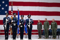 Honor guard post the colors while leadership stands at the side.