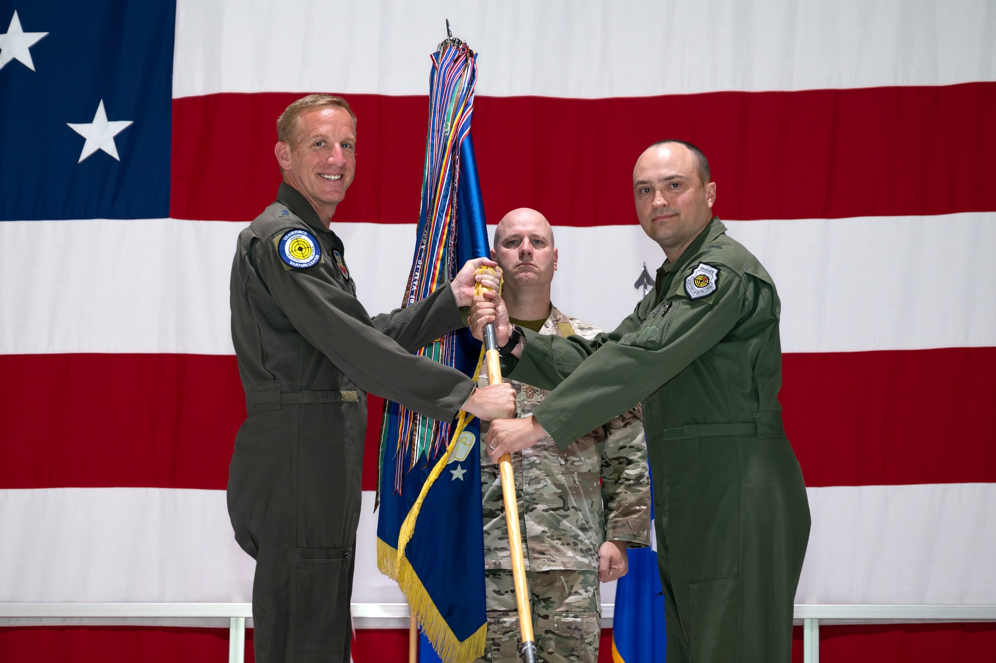 U.S. Air Force Warfare Center commander passes the guidon to new 57th Wing commander
