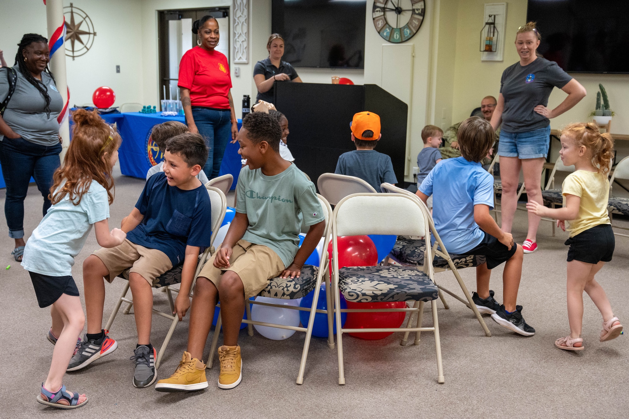 Children from the 97th Air Mobility Wing play a game of musical chairs during the Bring Your Kids to Work Day event at Altus Air Force Base, Oklahoma, July 3, 2024. Airmen had the opportunity to show their families the work they do across the installation and participate in games and hands-on learning activities. (U.S. Air Force photo by Airman 1st Class Heidi Bucins)