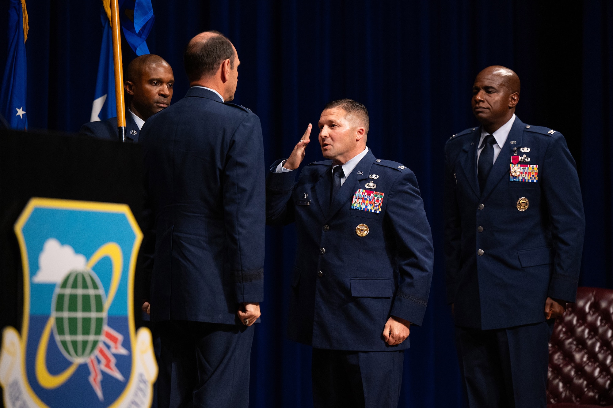 Col. Creighton A. Mullins renders a salute to Lt. Gen. Kevin B. Kennedy as he assumes command of the Air Force Technical Applications Center, Patrick Space Force Base, Fla.  Kennedy, commander of 16th Air Force, presided over the ceremony July 11, 2024.  Also pictured are outbound AFTAC commander Col. James A. Finlayson, and Chief Master Sgt. Jerome Wright, AFTAC’s command chief.  (U.S. Air Force Photo by Amanda Inman)