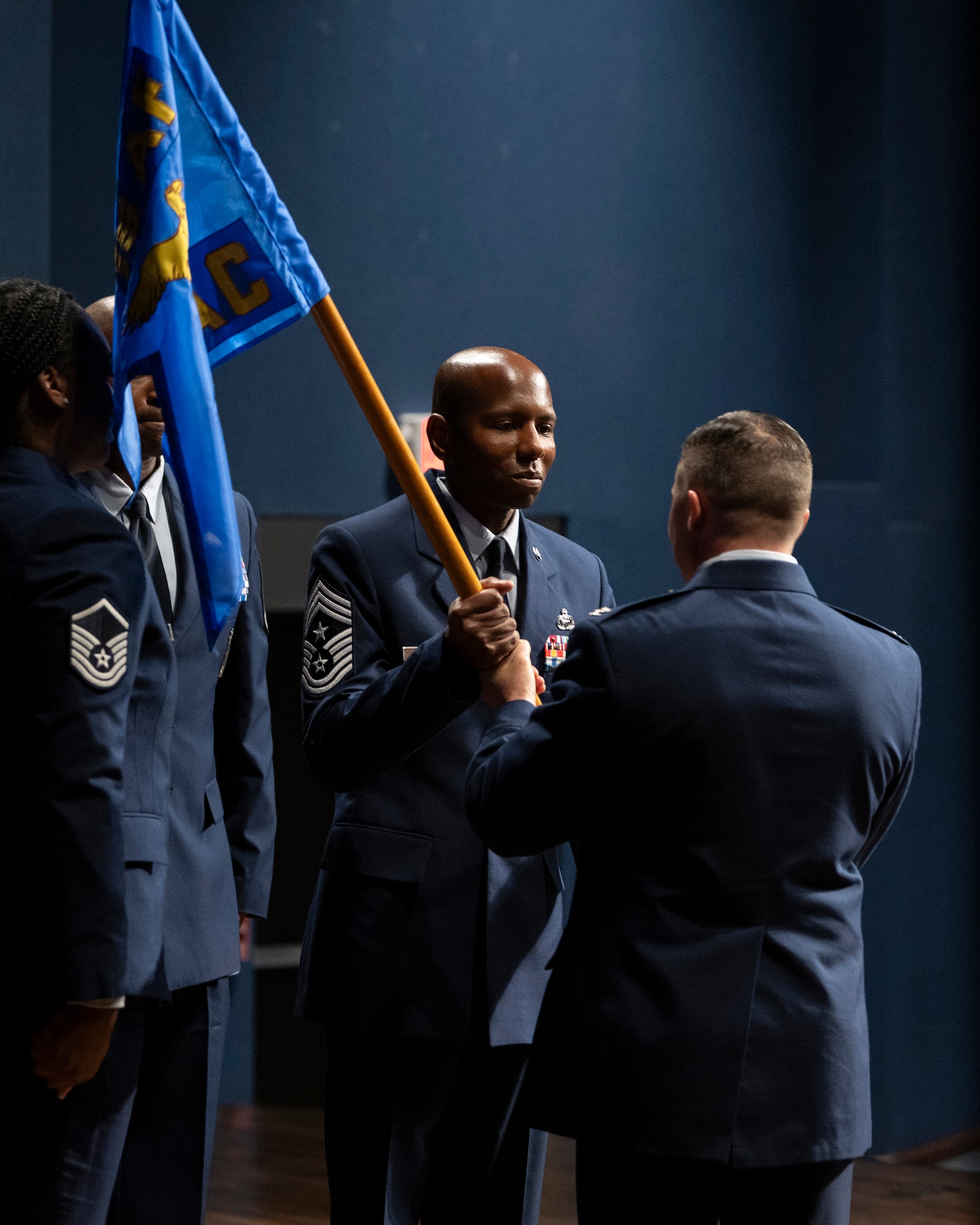 Chief Master Sgt. Brian Mitchell accepts the guidon from Col. Creighton A. Mullins during a Change of Responsibility ceremony July 11, 2024 at Patrick Space Force Base, Fla., where Mitchell became Mullins’ new command chief at the Air Force Technical Applications Center.  (U.S. Air Force photo by Matthew S. Jurgens)