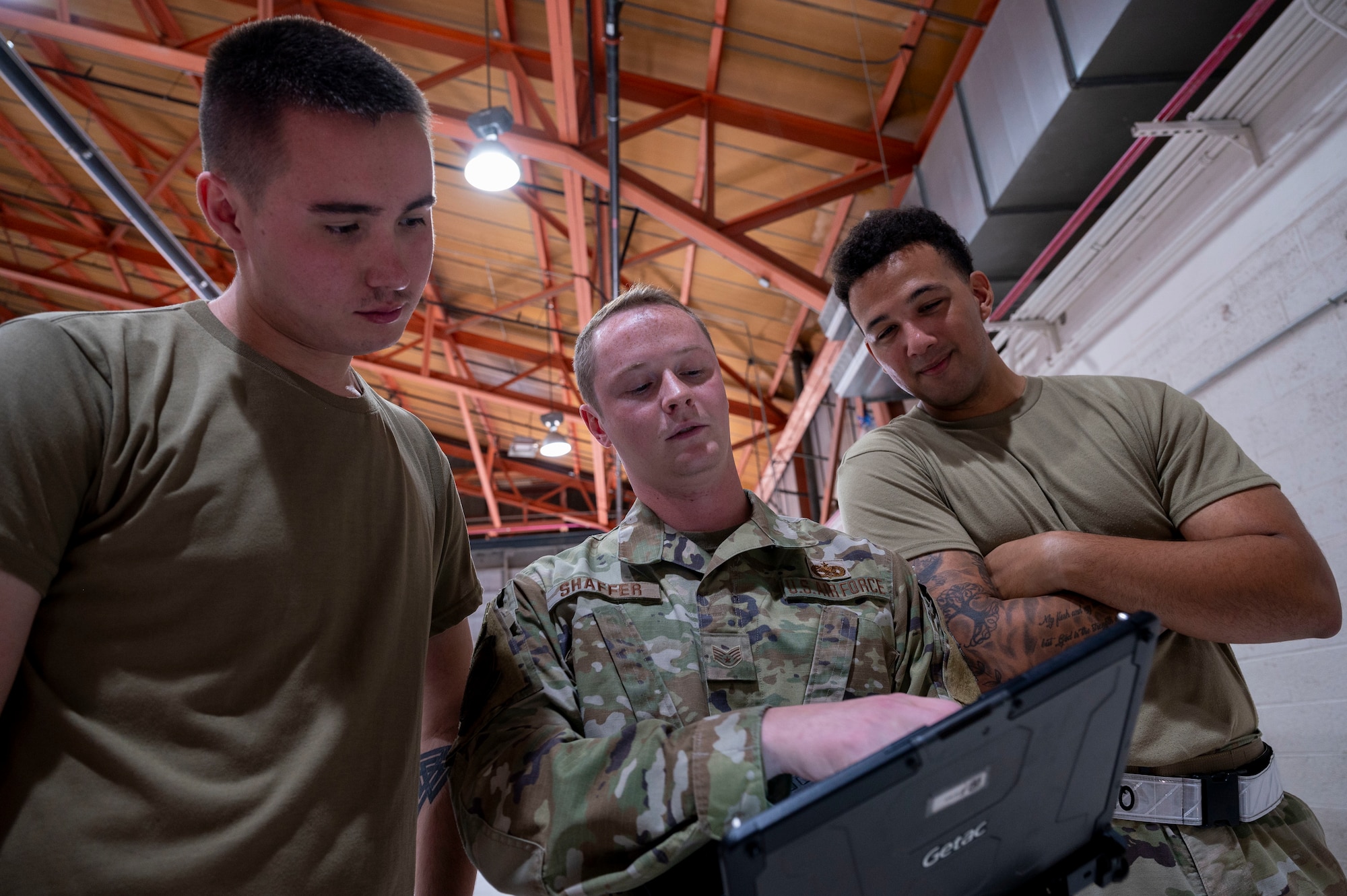 U.S. Air Force Staff Sgt. Caleb Wilson, 49th Aircraft Maintenance Squadron dedicated crew chief, left, and U.S. Air Force Staff Sgt. Shaun Shaffer, 49th AMXS DCC, center, and U.S. Air Force Staff Sgt. Jose Lopez-Flecha, 49th AMXS quality assurance, reviews technical orders for the MQ-9 Reaper at Holloman Air Force Base, New Mexico July 10, 2024.