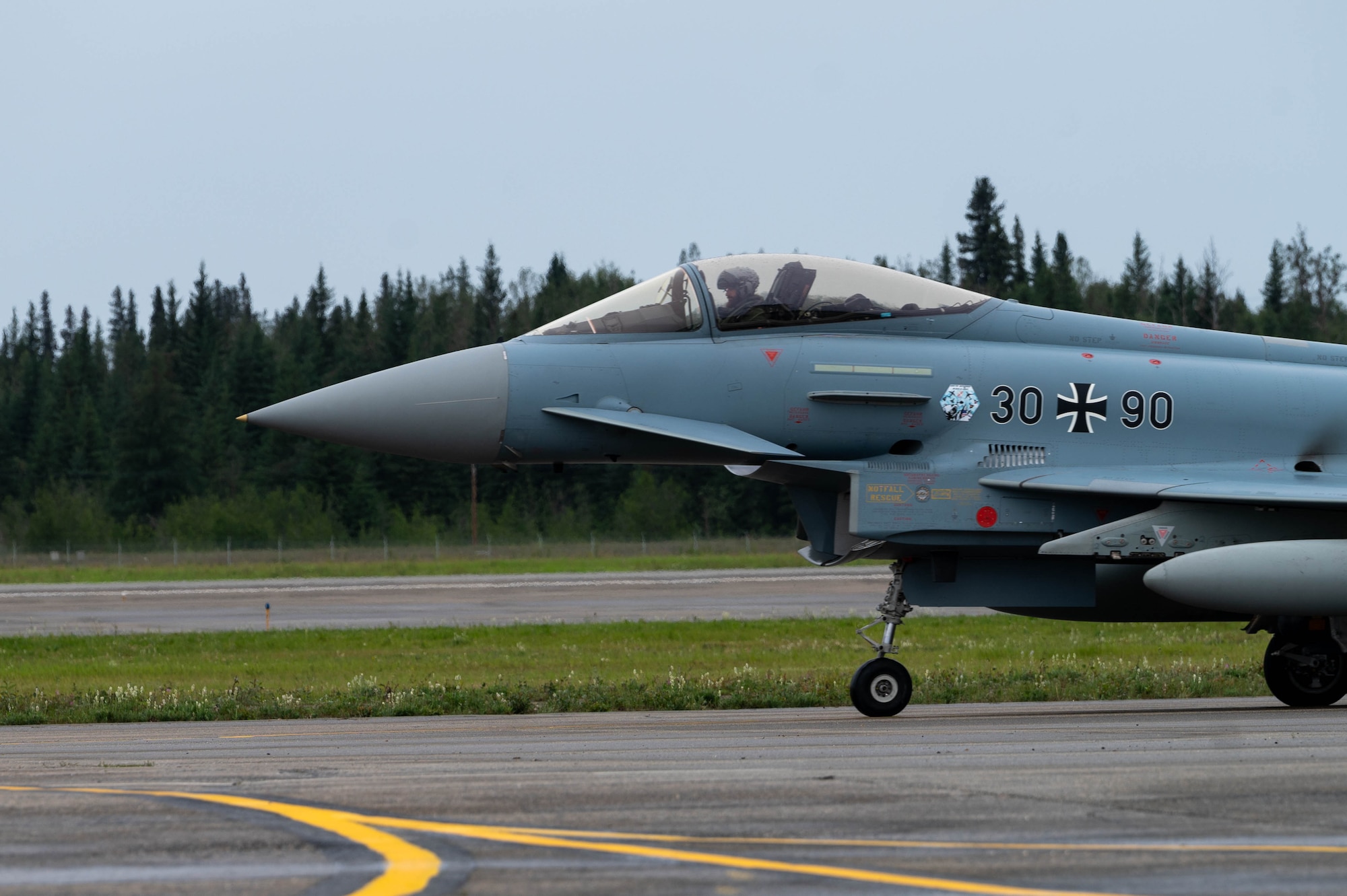 A German Air Force Eurofighter Typhoon aircraft taxis on the flightline.