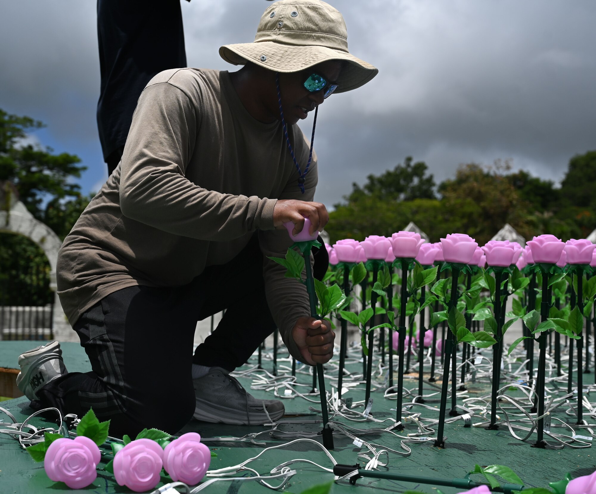 U.S. Air Force Staff Sgt. Joseph Wolfe assigned to the 554th Red Horse Squadron, Andersen Air Force Base, Guam, places a flower luminary into a static display of Guam being set up at the Plaza de España in Hagatña, July 9, 2024. The luminary display will be lit up from July 19-21 in commemoration of the 80th Guam Liberation day. (U.S. Air Force photo by Airman 1st Class Natasha Ninete)