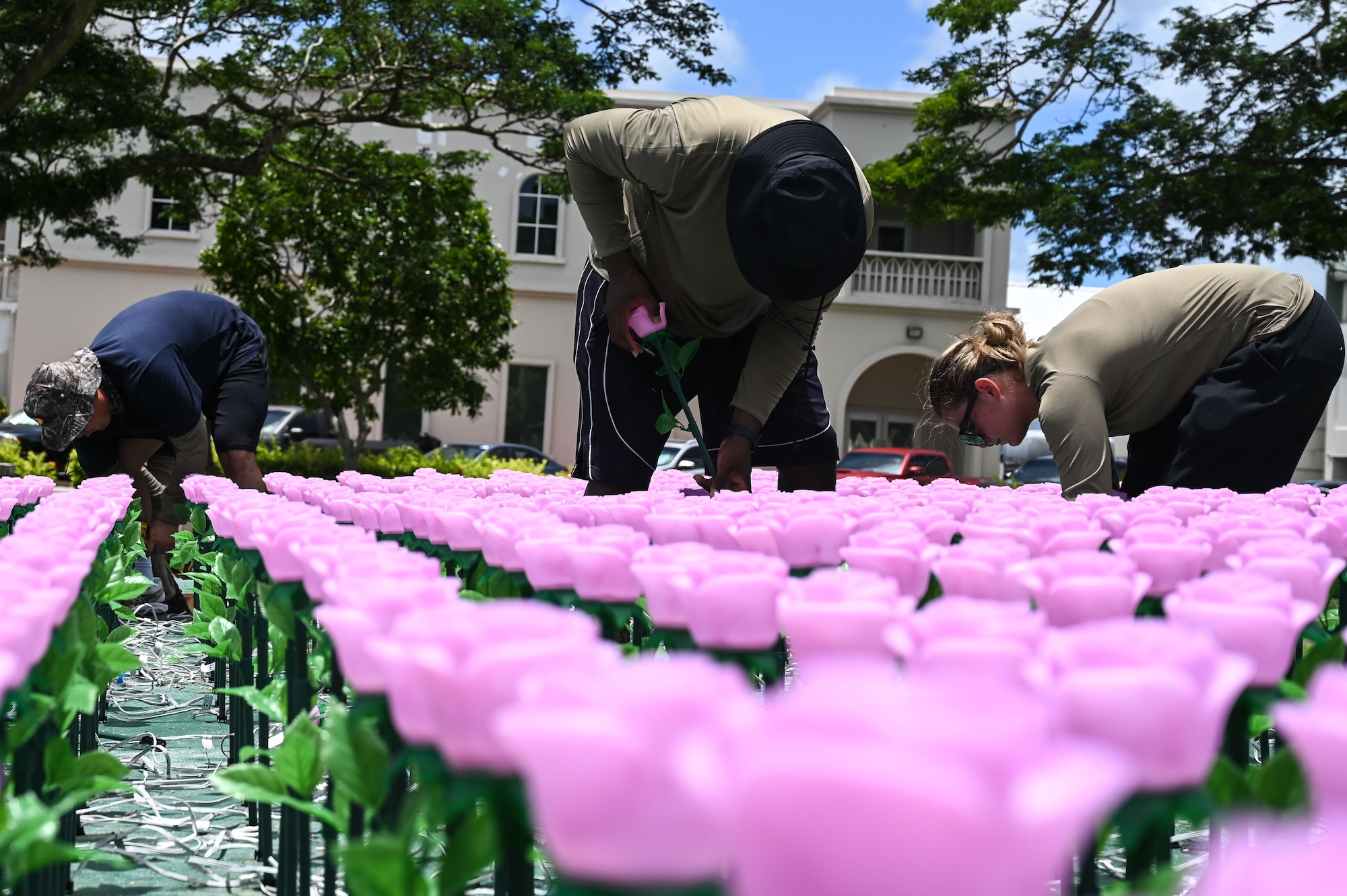 U.S. Air Force Airmen assigned to the 554th Red Horse Squadron, Andersen Air Force Base, Guam, volunteer to plant over 3,000 flower luminaries into a static display of Guam at the Plaza de España in Hagatña, July 9. 2024. The flowers represent the lives lost during the liberation of Guam and will be lit up from July 19-21 in commemoration of the 80th Guam Liberation Day. (U.S. Air Force photo by Airman 1st Class Natasha Ninete)