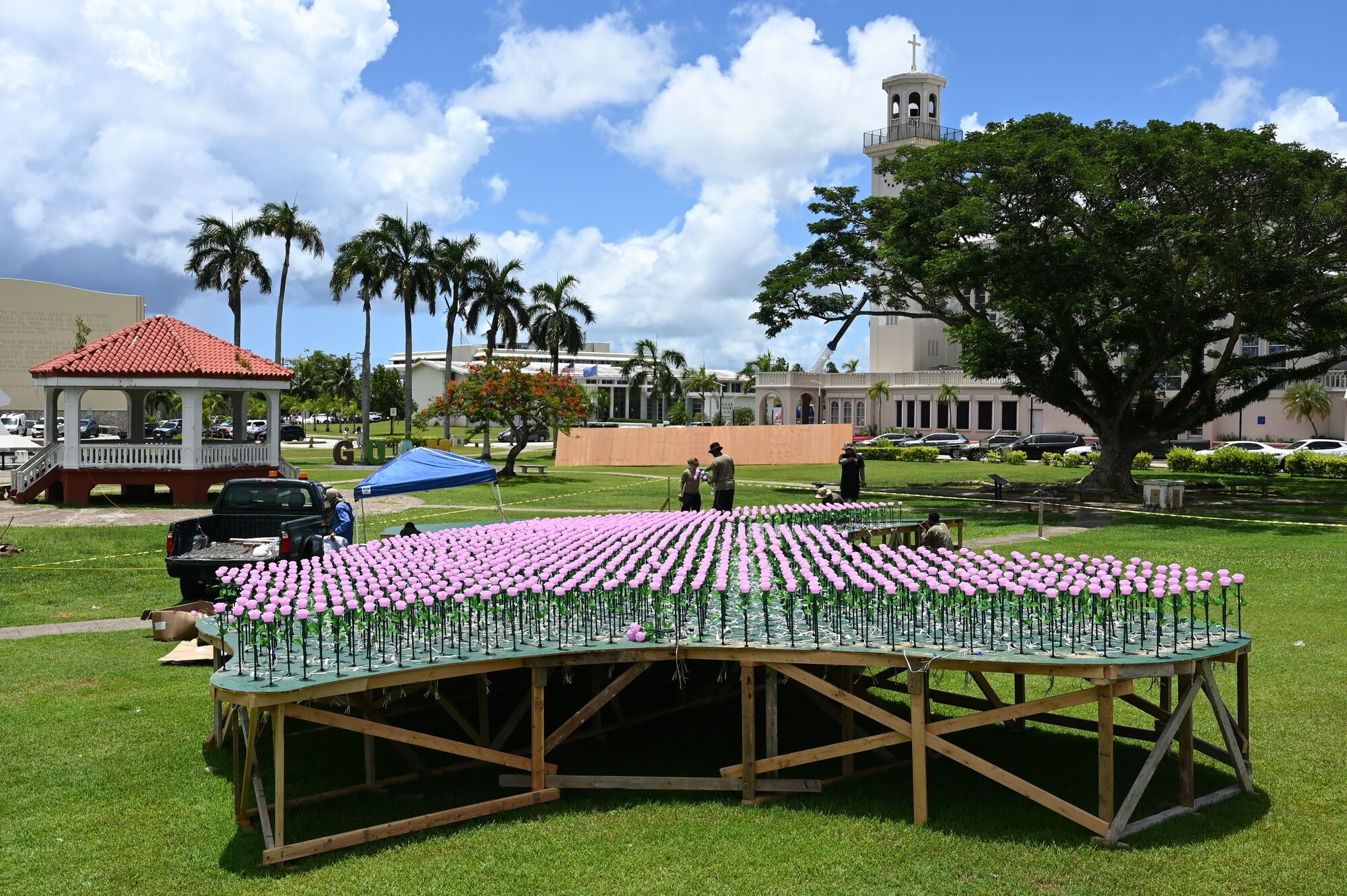 U.S. Air Force Airmen assigned to the 554th Red Horse Squadron, Andersen Air Force Base, Guam, plant over 3,000 flower luminaries into a static display of Guam at the Plaza de España in Hagatña, Guam, July 9, 2024. The display will be lit up from July 19-21 as part of the 80th Guam Liberation Day celebrations. (U.S. Air Force photo by Airman 1st Class Natasha Ninete)