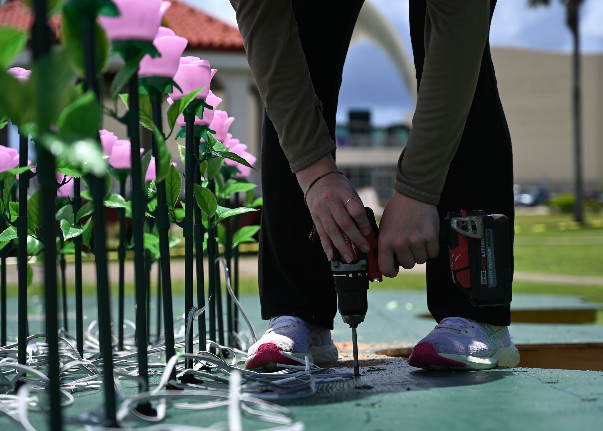 A U.S. Air Force Airman drills a hole into a static display of Guam at the Plaza de España in Hagatña, Guam, July 9, 2024. The 554th Red Horse Squadron volunteered with the Sinajaña Mayor’s Office to set up the luminary display designed to commemorate the over 3,000 lives lost during the liberation of Guam in 1944. (U.S. Air Force photo by Airman 1st Class Natasha Ninete)