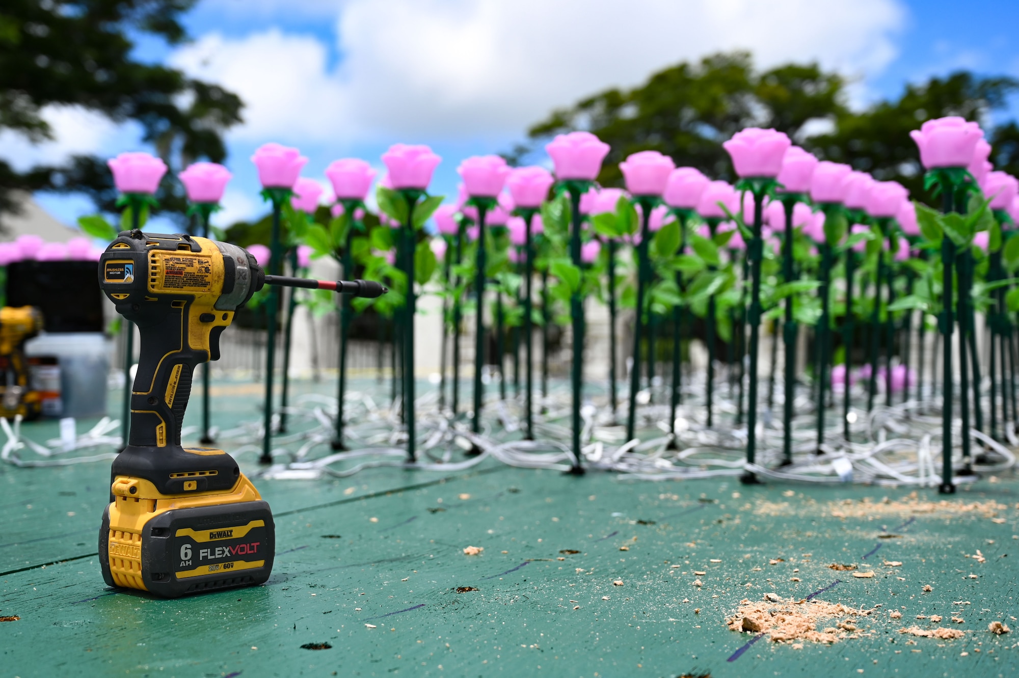 Flower luminaries are installed one at a time into a static display of Guam at the Plaza de España in Hagatña, Guam, July 9, 2024. Airmen from the 554th Red Horse Squadron planted over 3,000 flowers to commemorate the lives lost during the liberation of Guam almost 80 years ago. (U.S. Air Force photo by Airman 1st Class Natasha Ninete).
