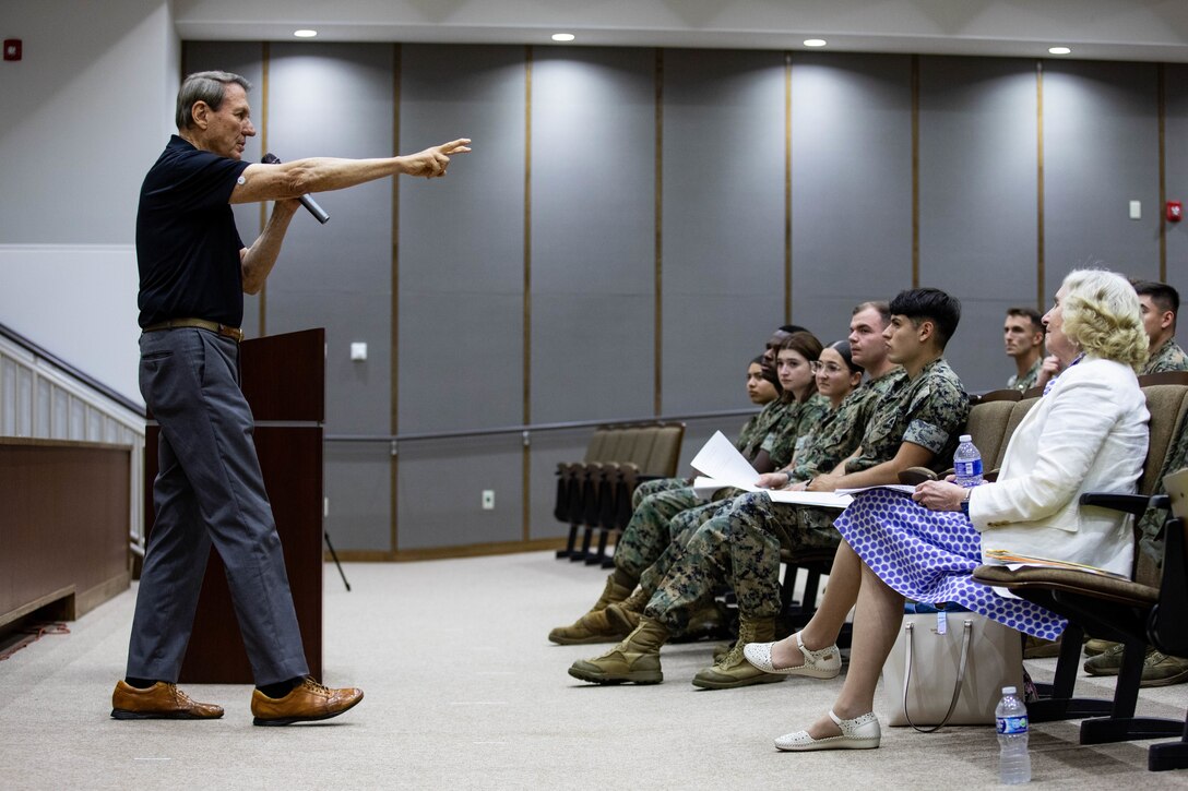 Phil Downer, a former machine gunner with Hotel Company, 2nd Battalion, 5th Marine Regiment, during the Vietnam War, currently a professional speaker, addresses a crowd of U.S. service members at Marine Corps Air Station Iwakuni, Japan, June 20, 2024. Downer’s former company during the Vietnam War was featured in the movie "Full Metal Jacket”. Downer now travels all over the world to share the practical steps to a resilient life and the pursuit of excellence by covering topics such as core values, leadership, and recovering from trauma. (U.S. Marine Corps photos by Lance Cpl. Dahkareo Pritchett)