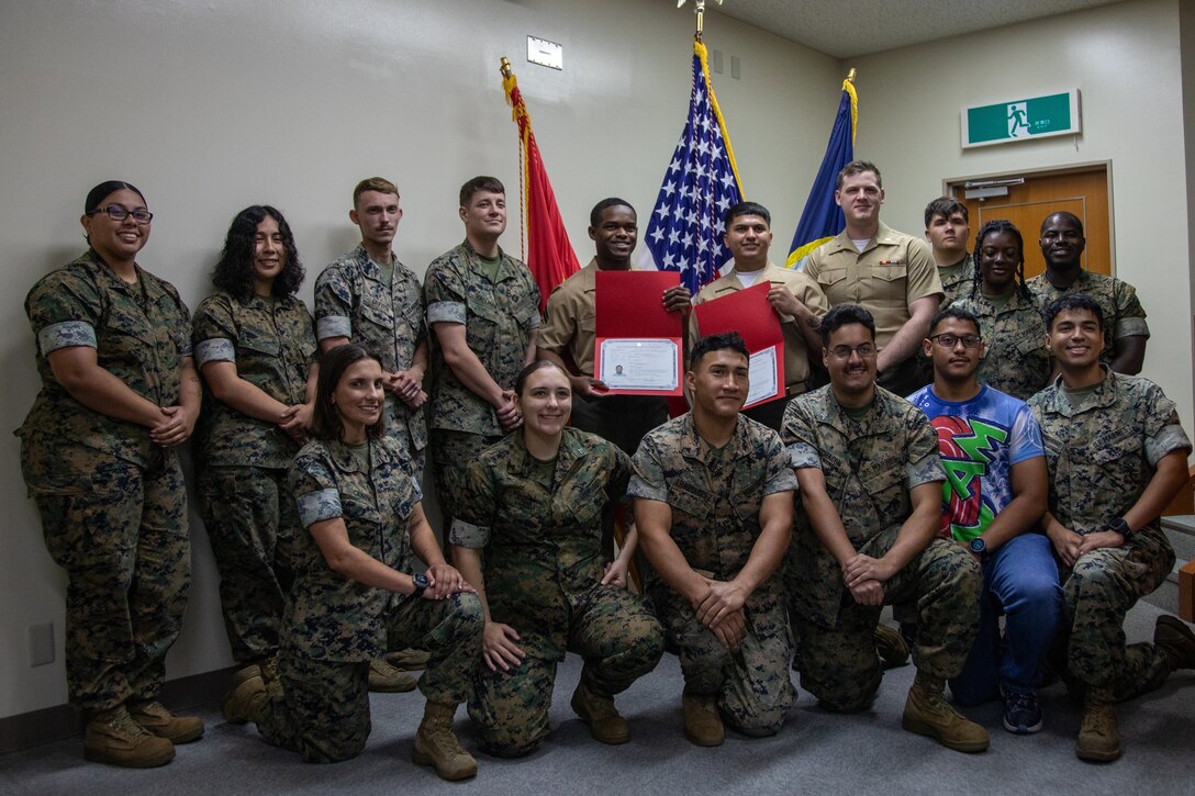U.S. Marines pose for a photo during a naturalization ceremony at Marine Corps Air Station Iwakuni, Japan, June 28, 2024. The naturalization ceremony was held to acknowledge the MCAS Iwakuni service members’ achievement of becoming citizens of the United States. The ceremony included service members from Nigeria and Nepal (U.S. Marine Corps Photo by Lance Cpl. Rylan Adcock)