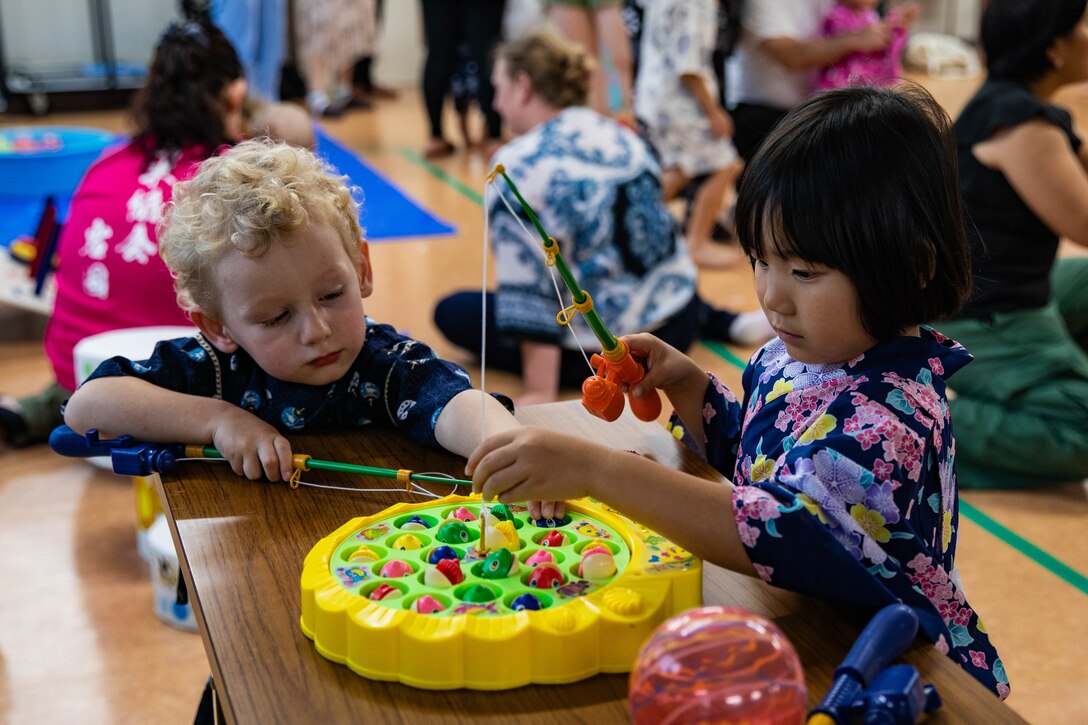 Children play a fishing board game during the Tanabata Star Festival in Iwakuni, Japan, June 29, 2024. The Tanabata Star Festival is a Japanese holiday celebrated by writing wishes and hanging them from bamboo trees. (U.S Marine Corps photo by Lance Cpl. Dahkareo Pritchett)